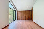 Discover a modern bedroom with stunning natural light and a serene view.