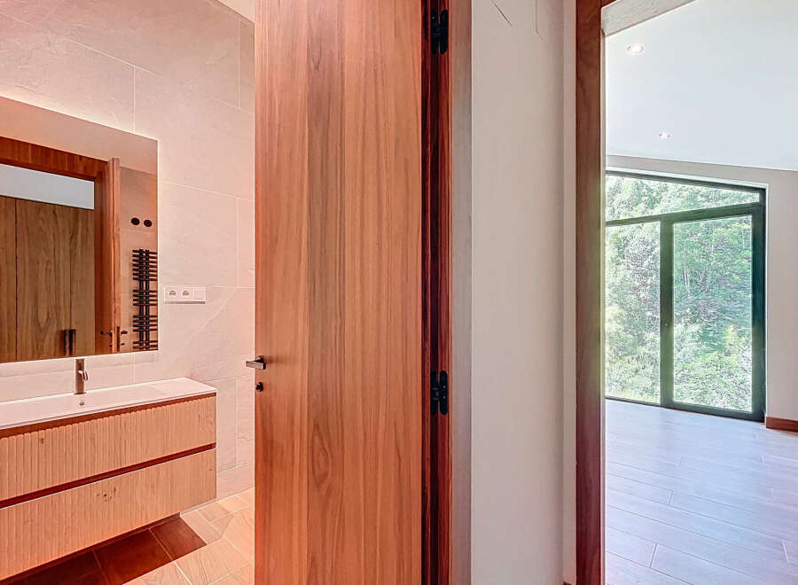 Step into a beautifully designed bathroom with a modern vanity and a sleek mirror.
