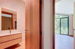 Step into a beautifully designed bathroom with a modern vanity and a sleek mirror.