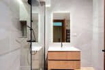 Modern bathroom design featuring a sleek shower with a rain showerhead and a stylish vanity.