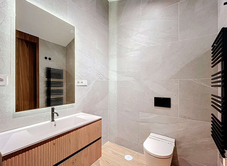 This modern bathroom boasts sleek design with its neutral color palette and contemporary fixtures.