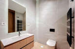 This modern bathroom boasts sleek design with its neutral color palette and contemporary fixtures.
