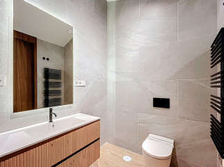 This modern bathroom boasts sleek design with its neutral color palette and contemporary fixtures.