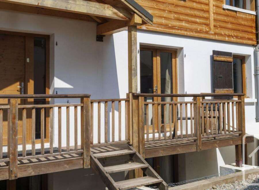 Discover the charm of this stunning property, featuring a beautifully crafted wooden deck and inviting entrance.