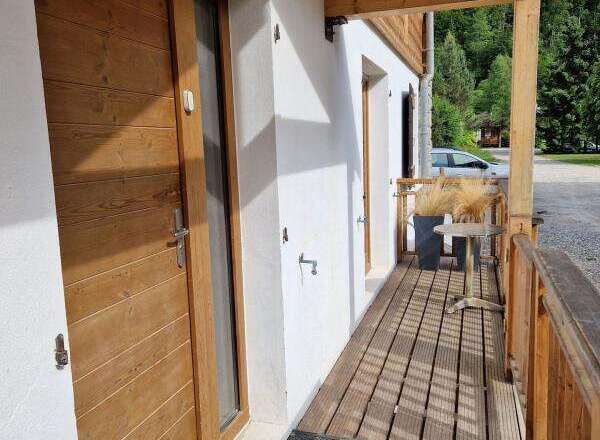 Discover the charm of this inviting property, featuring a beautifully crafted wooden door and a welcoming porch.