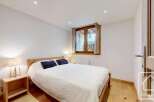 Discover the charm of this cozy bedroom, featuring a comfortable bed and inviting ambiance.