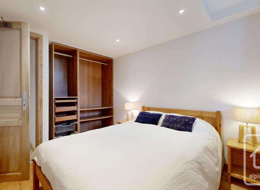 Discover the charm of this inviting bedroom, featuring a cozy bed and ample storage.