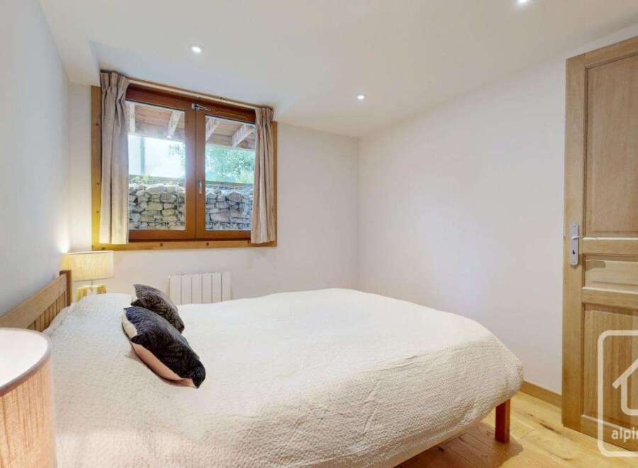 This cozy bedroom features a comfortable bed, perfect for a relaxing retreat.