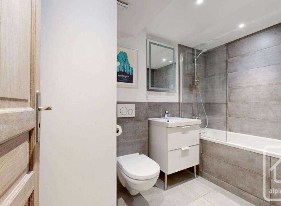 Discover modern living in this stylish bathroom! Featuring sleek gray tiles, a contemporary vanity, and a refreshing shower, this space offers both functionality and elegance.