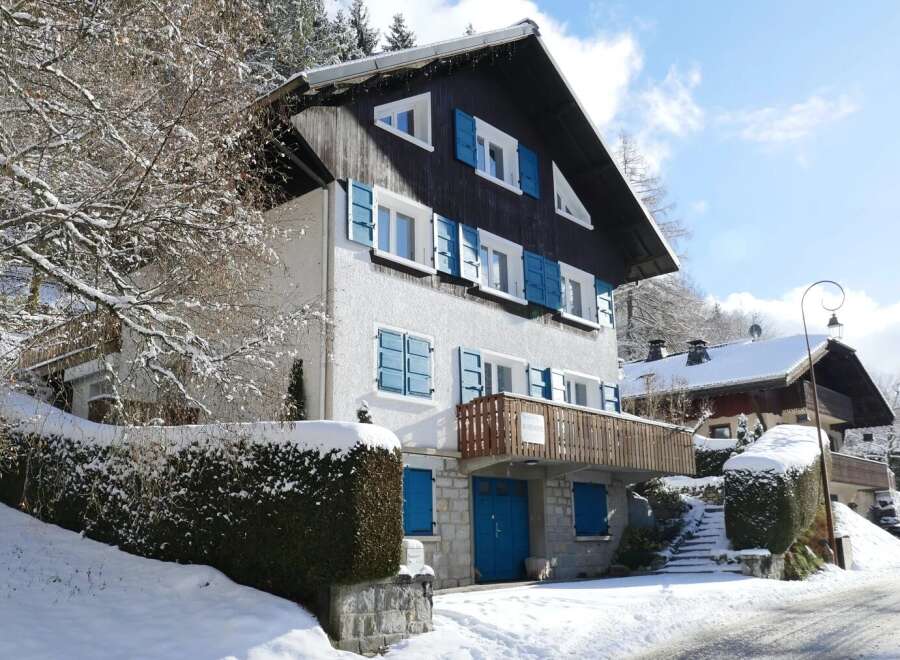 Discover a charming chalet nestled in a snowy landscape, perfect for a winter getaway.