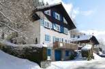 Discover a charming chalet nestled in a snowy landscape, perfect for a winter getaway.