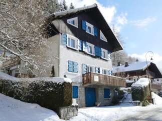 Discover a charming chalet nestled in a snowy landscape, perfect for a winter getaway.