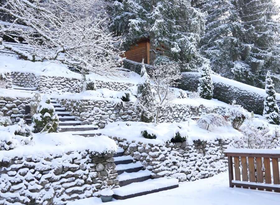 This stunning property showcases a picturesque winter landscape, perfect for those seeking a serene retreat.
