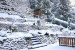 This stunning property showcases a picturesque winter landscape, perfect for those seeking a serene retreat.