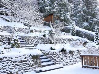 This stunning property showcases a picturesque winter landscape, perfect for those seeking a serene retreat.