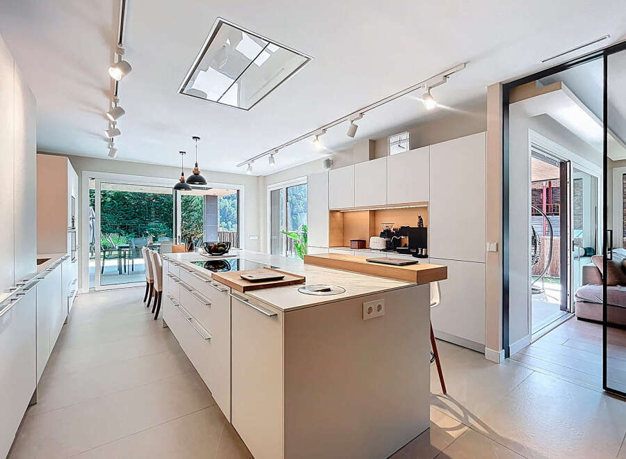 This modern kitchen boasts sleek, minimalist design with ample storage and a spacious island.