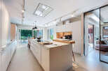 This modern kitchen boasts sleek, minimalist design with ample storage and a spacious island.