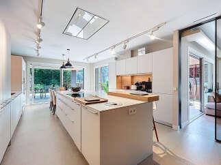 This modern kitchen boasts sleek, minimalist design with ample storage and a spacious island.