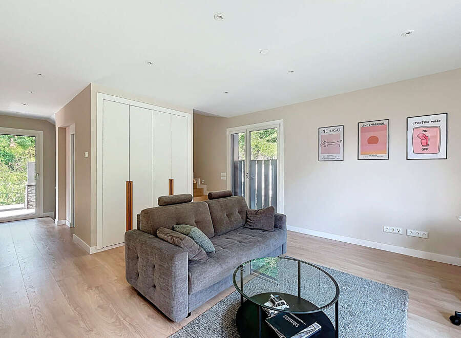 Step into a modern living space with a stylish sofa and a chic glass coffee table.