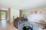 Step into a modern living space with a stylish sofa and a chic glass coffee table.