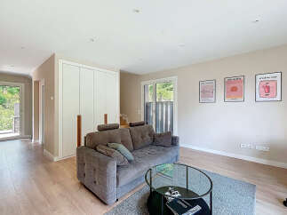 Step into a modern living space with a stylish sofa and a chic glass coffee table.
