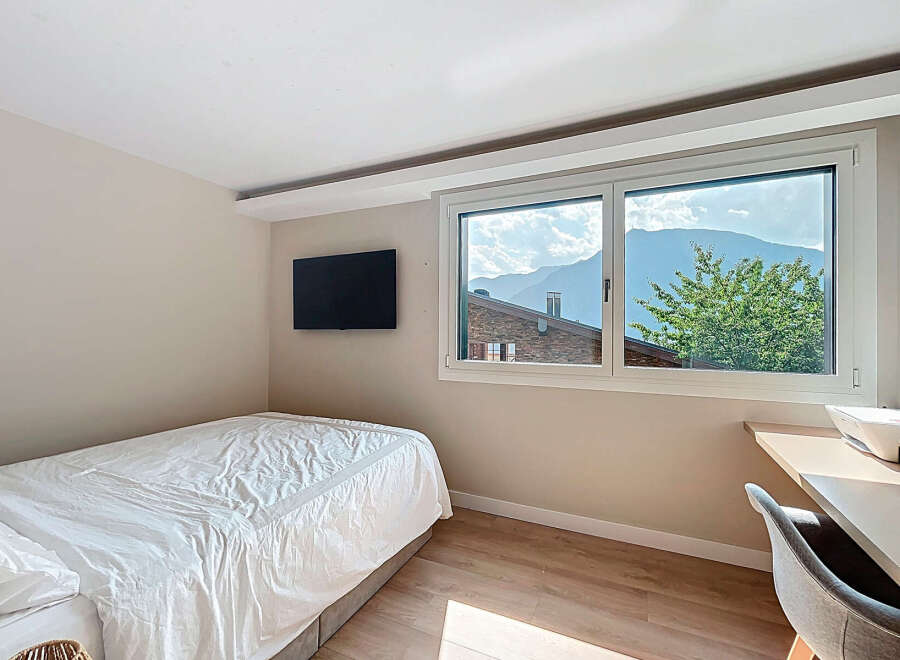 Cozy bedroom with a stunning mountain view.