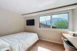 Cozy bedroom with a stunning mountain view.