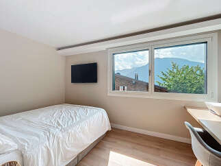 Cozy bedroom with a stunning mountain view.