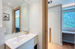 Modern bathroom design featuring a sleek white vanity and a large mirror.