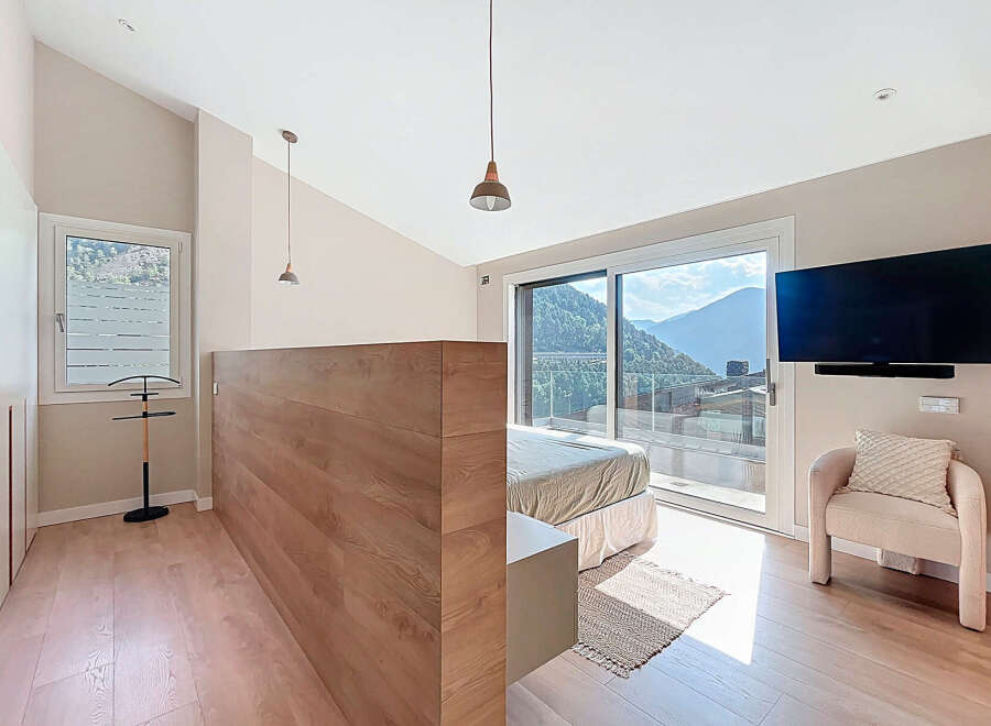 Experience luxury living in this stunning bedroom with breathtaking mountain views.