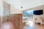 Experience luxury living in this stunning bedroom with breathtaking mountain views.