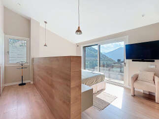 Experience luxury living in this stunning bedroom with breathtaking mountain views.