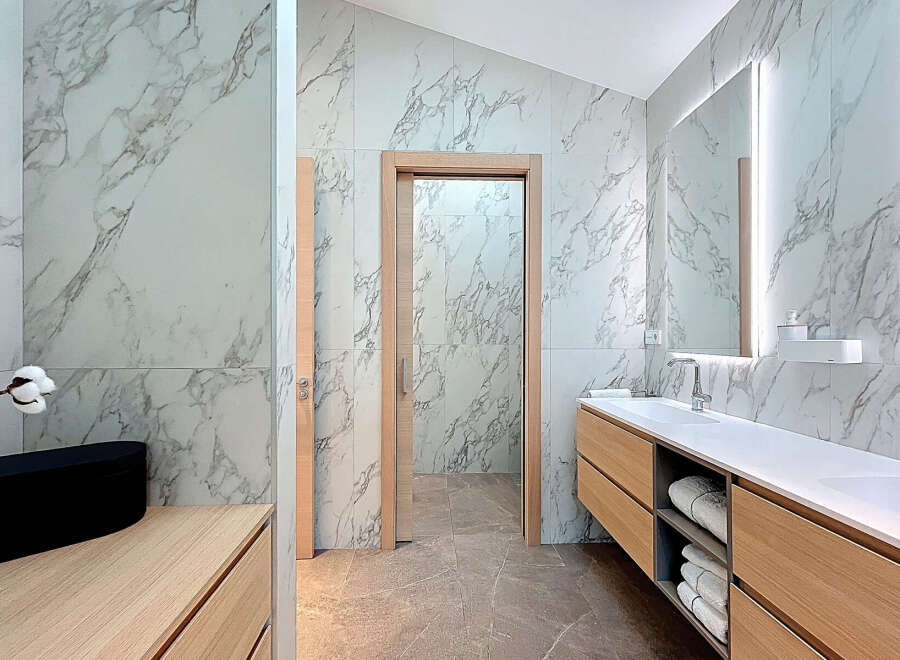 Discover a luxurious bathroom retreat with stunning marble accents and modern design.