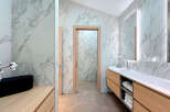 Discover a luxurious bathroom retreat with stunning marble accents and modern design.