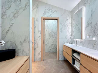 Discover a luxurious bathroom retreat with stunning marble accents and modern design.
