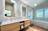 This luxurious bathroom boasts a modern design with elegant marble accents.