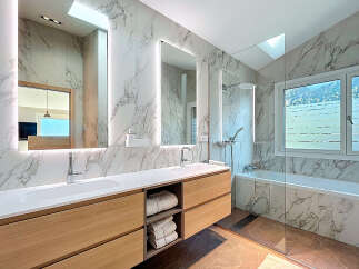 This luxurious bathroom boasts a modern design with elegant marble accents.
