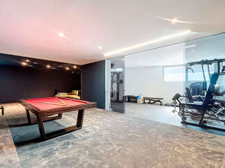 This luxurious property boasts a stunning game room with a pool table, perfect for entertaining.