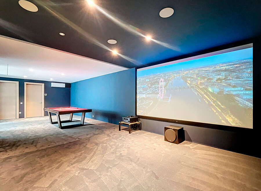 Step into luxury with this stunning home theater! Enjoy movie nights on a massive screen with immersive sound.