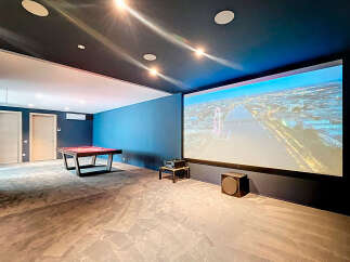 Step into luxury with this stunning home theater! Enjoy movie nights on a massive screen with immersive sound.