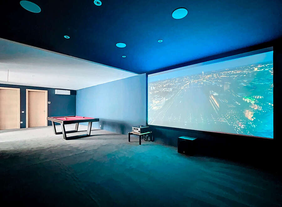 Step into luxury with this stunning entertainment room, perfect for movie nights and game days.