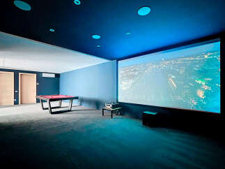 Step into luxury with this stunning entertainment room, perfect for movie nights and game days.