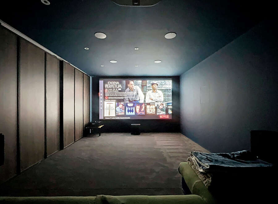 Step into your private home theater! This space features a large screen, perfect for movie nights.