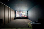 Step into your private home theater! This space features a large screen, perfect for movie nights.