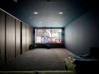 Step into your private home theater! This space features a large screen, perfect for movie nights.