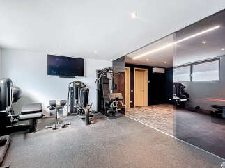 Step into your dream home gym! This space boasts state-of-the-art equipment, perfect for all your fitness needs.