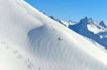 Experience the thrill of skiing down a pristine, snow-covered mountain.