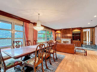 Elegant dining room with a stunning chandelier and a large dining table, perfect for hosting gatherings.