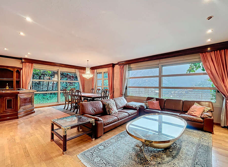 Discover luxury living in this stunning property, featuring a spacious living area with a comfortable leather sofa and a stylish coffee table.