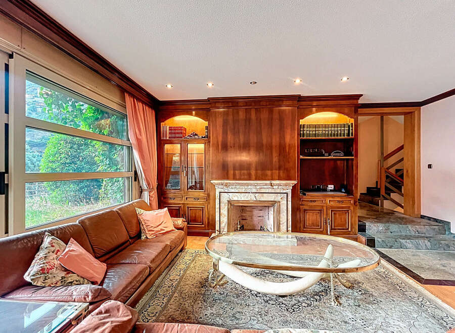 Elegant living room with a cozy fireplace and built-in bookshelves.
